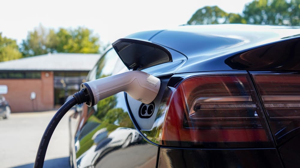 Samochód elektryczny ładowany przy tylnym porcie na ulicy